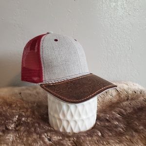 Ball cap with hand-sewn leather patch on brim.